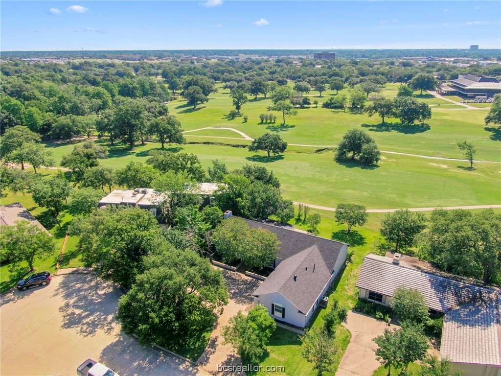 an aerial view of residential houses with outdoor space and river