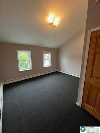a spacious bathroom with a granite countertop sink toilet and a mirror