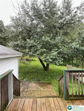 a view of a house with a wooden fence