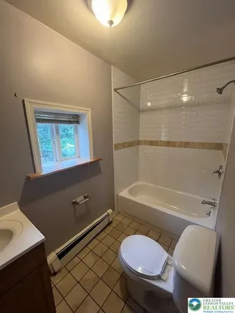 a bathroom with a toilet a sink and bathtub