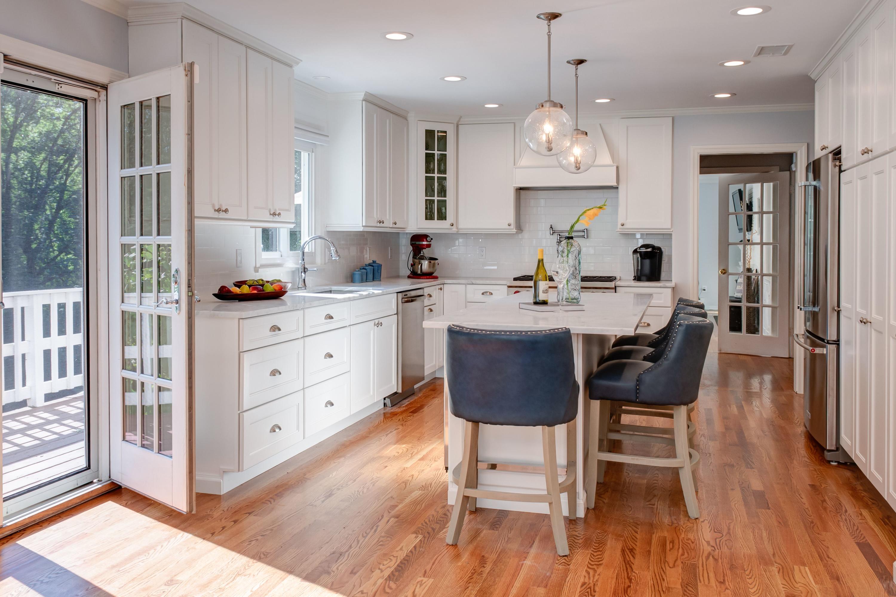134 Marshall Ridge Road New Canaan, CT 06840 - Photo 11 of 37 a kitchen with stainless steel appliances a dining table chairs stove refrigerator and cabinets