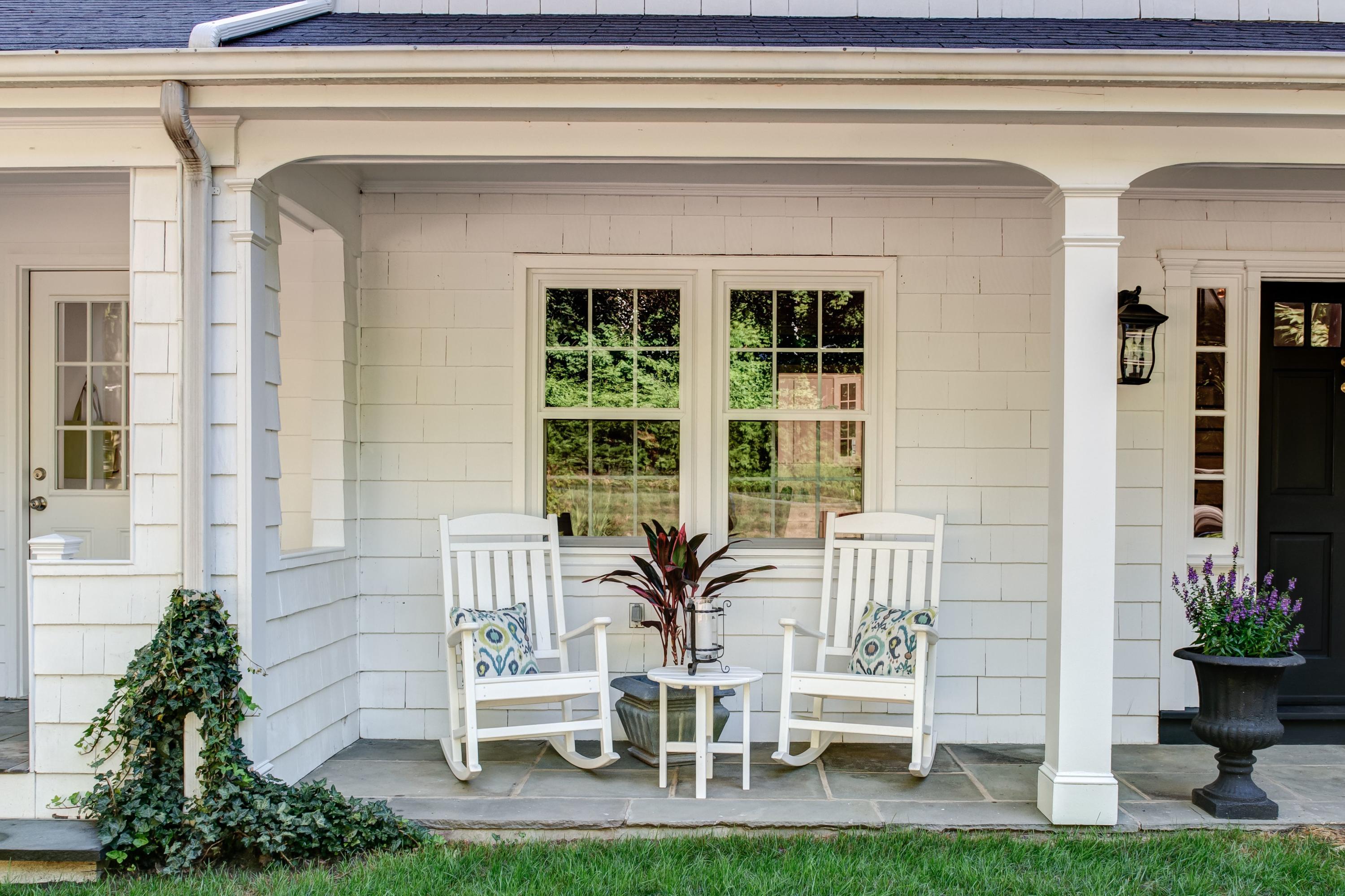 134 Marshall Ridge Road New Canaan, CT 06840 - Photo 3 of 37 a balcony with table and chairs and potted plants
