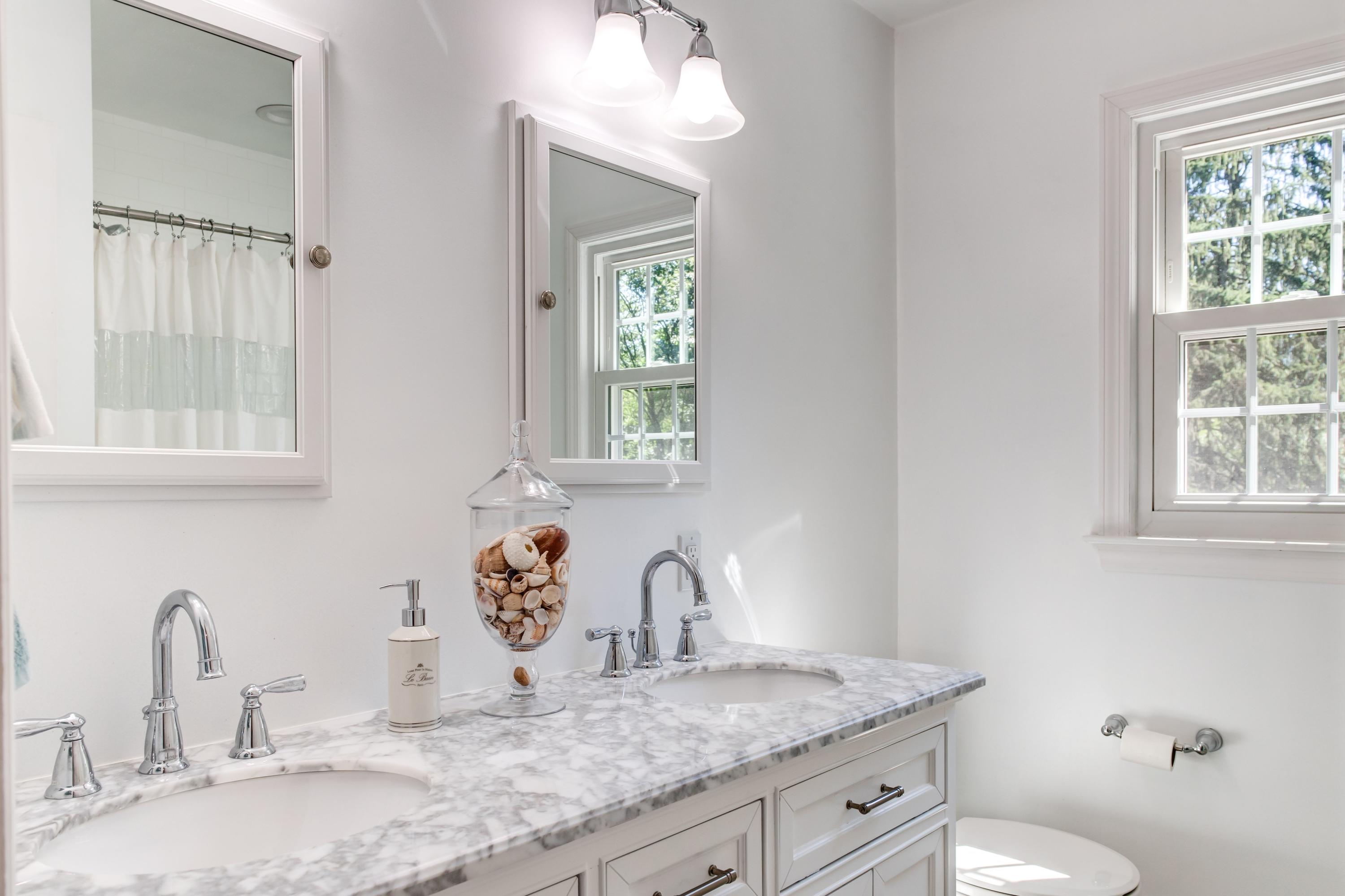 134 Marshall Ridge Road New Canaan, CT 06840 - Photo 24 of 37 a bathroom with a granite countertop sink and a mirror