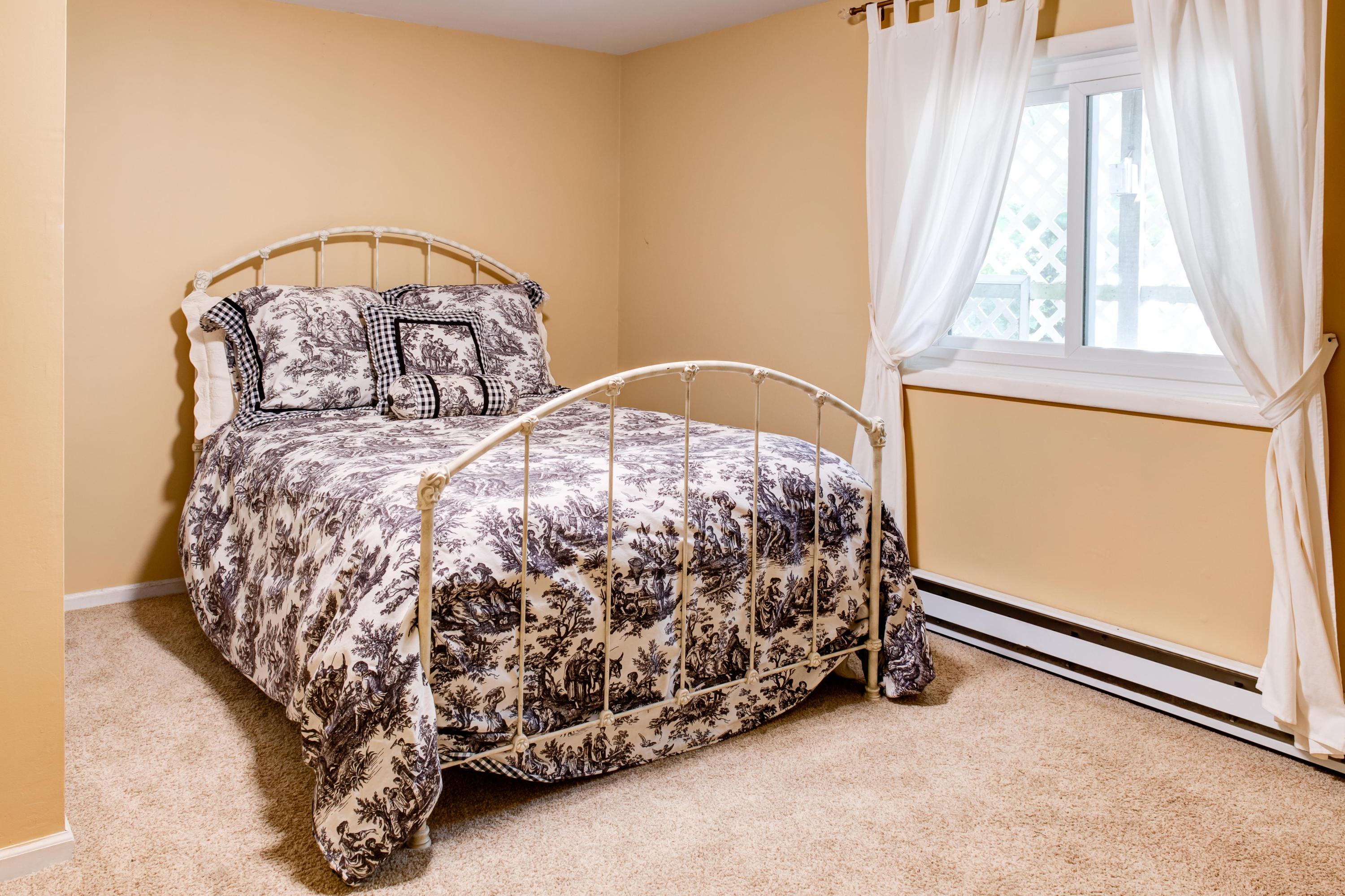 134 Marshall Ridge Road New Canaan, CT 06840 - Photo 31 of 37 a bed sitting in a bedroom next to a window