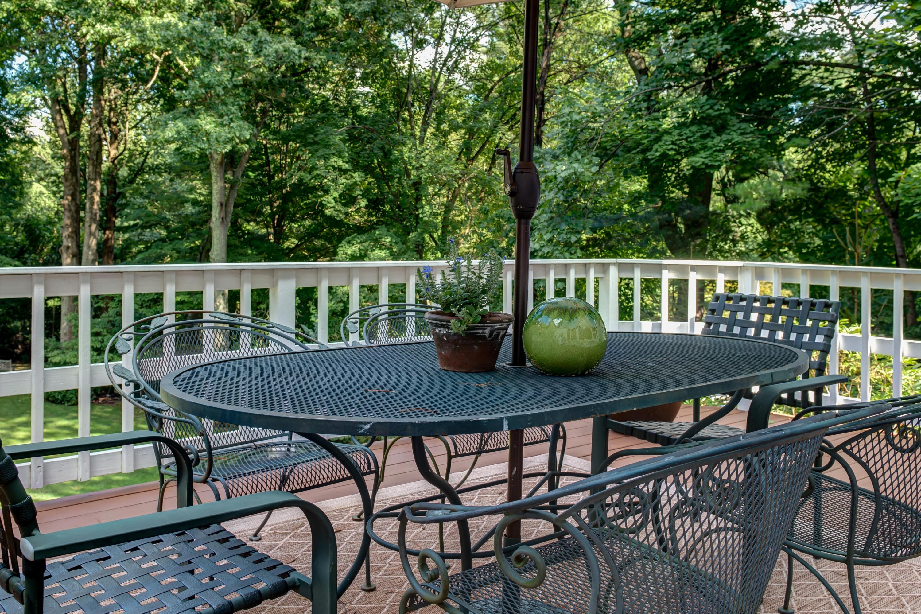 134 Marshall Ridge Road New Canaan, CT 06840 - Photo 34 of 37 a view of a balcony with chairs and wooden fence