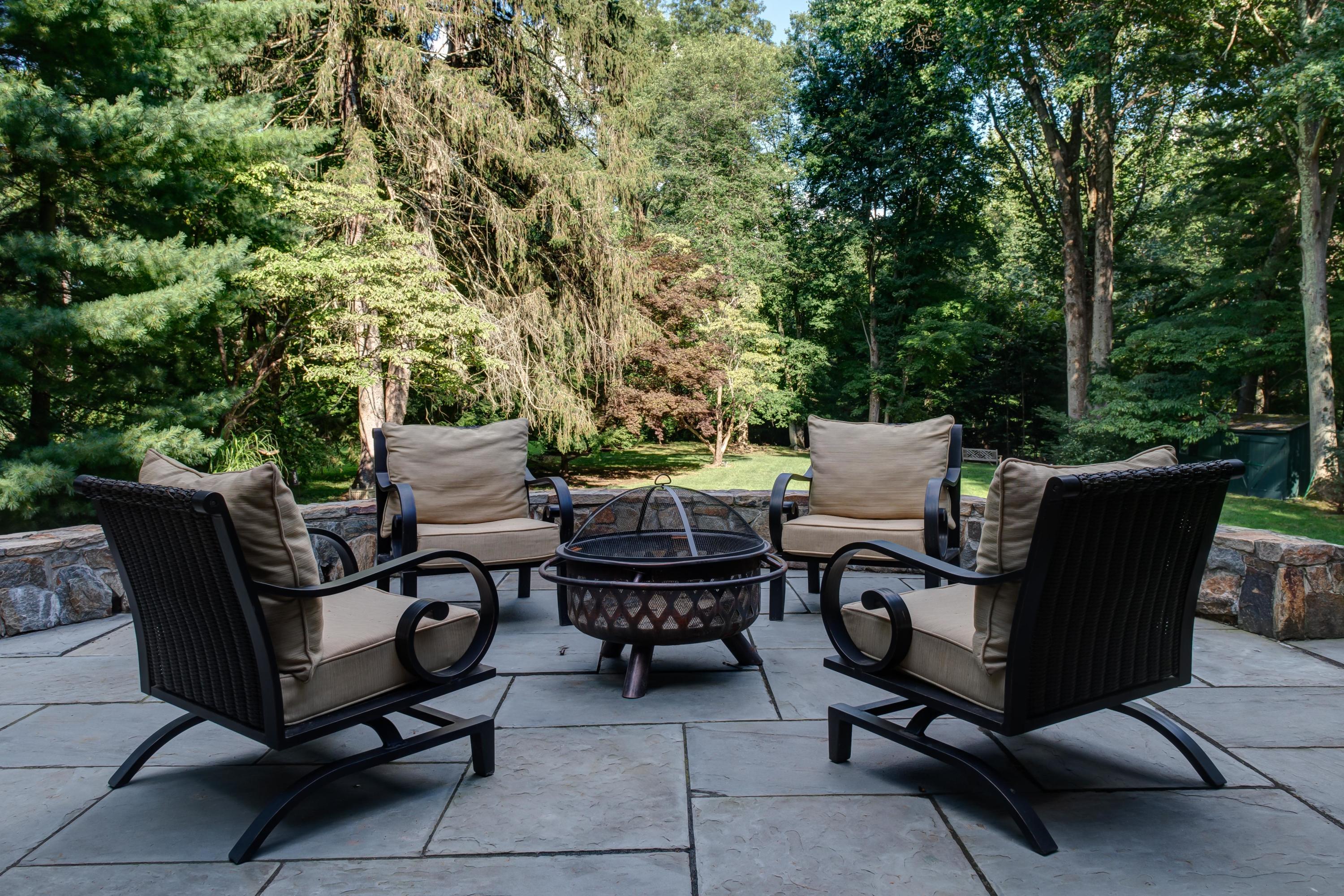 134 Marshall Ridge Road New Canaan, CT 06840 - Photo 36 of 37 a view of a patio with table and chairs and a barbeque