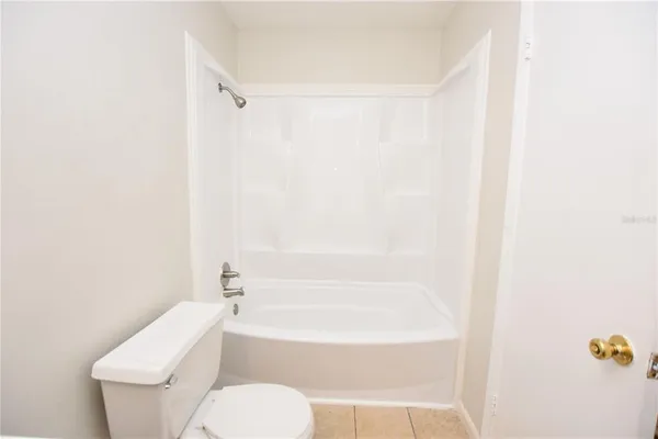 a bathroom with a toilet and a bathtub