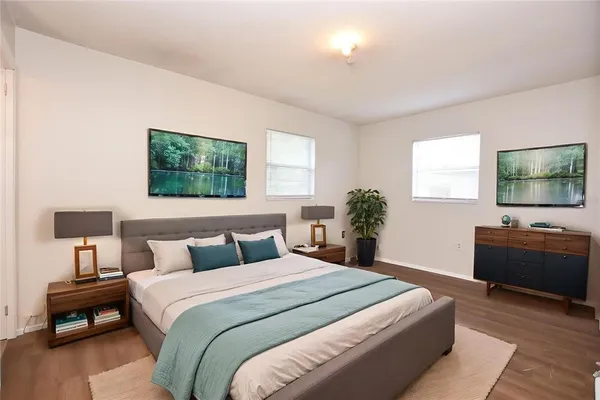 a bedroom with a bed and a flat screen tv