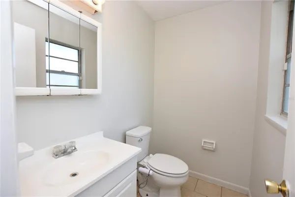 a bathroom with a sink mirror and toilet