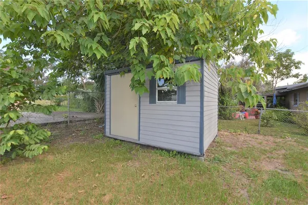 a view of a house with a yard and tree s
