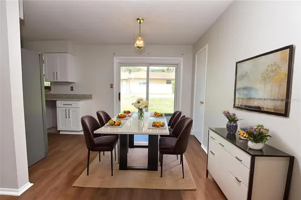 a view of a dining room with furniture window and wooden floor
