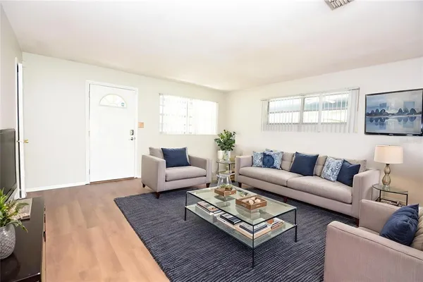 a living room with furniture a rug and a window