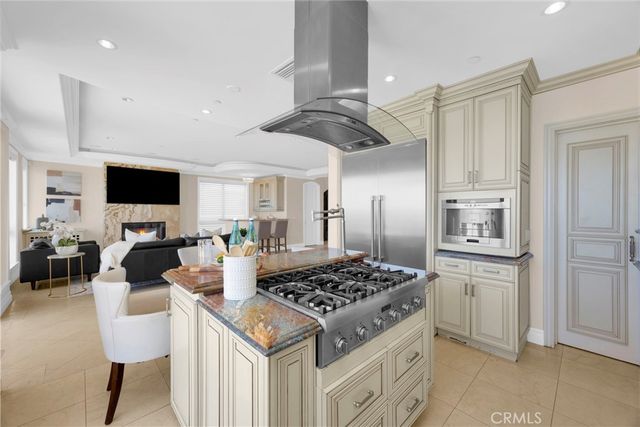 a spacious bedroom with a bed and a chandelier