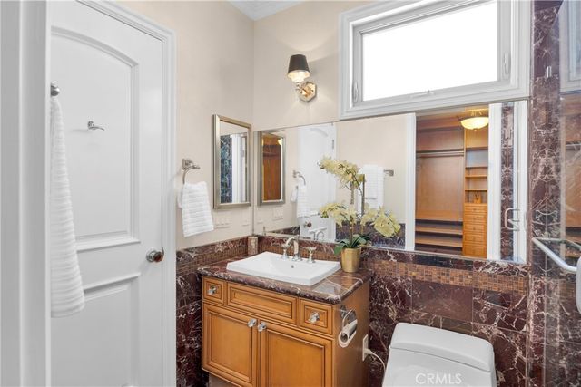 a view of a patio with couches table and chairs and potted plants