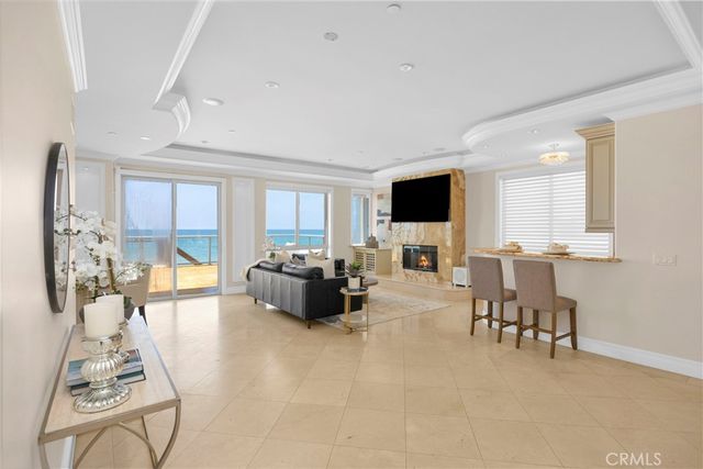 a living room with a couch and chandelier