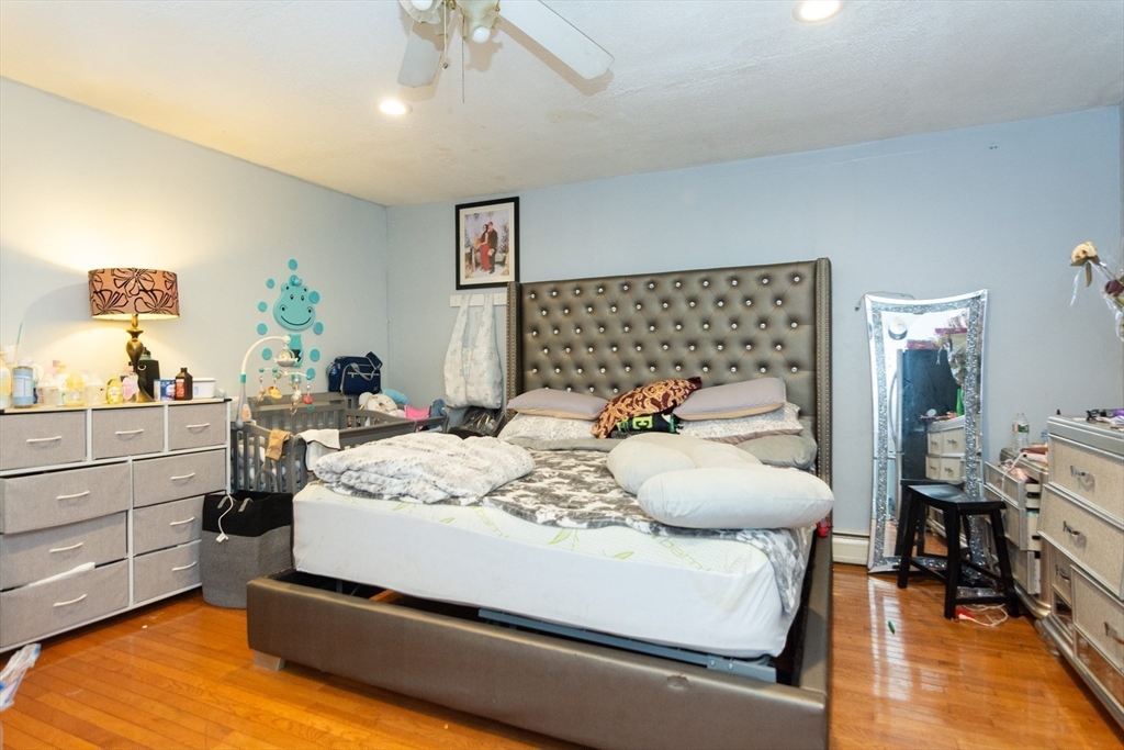 14 Russell Street Everett, MA 02149 - Photo 13 of 32 a bedroom with a bed and wooden floor