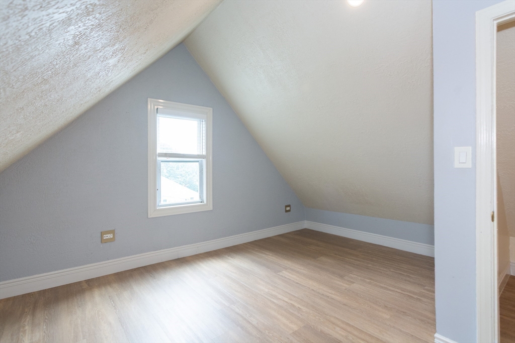 14 Russell Street Everett, MA 02149 - Photo 16 of 32 an empty room with wooden floor and windows