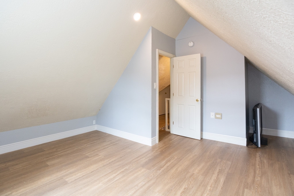 14 Russell Street Everett, MA 02149 - Photo 18 of 32 an empty room with wooden floor and windows