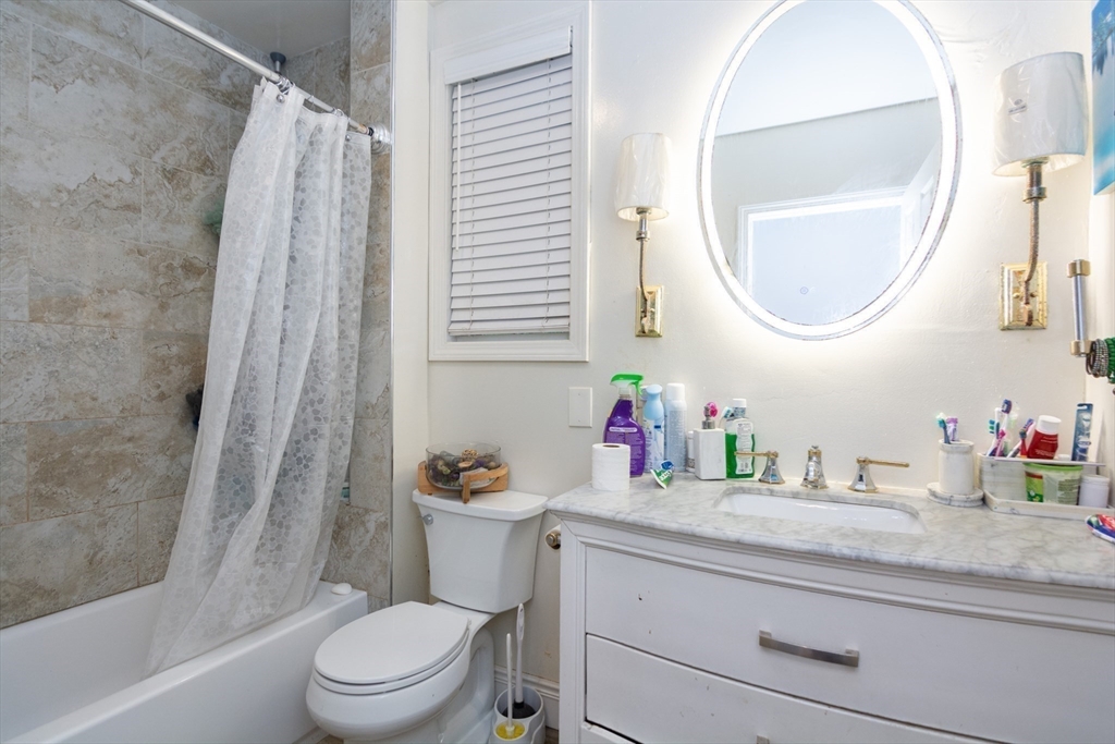 14 Russell Street Everett, MA 02149 - Photo 23 of 32 a bathroom with a granite countertop sink mirror vanity and toilet