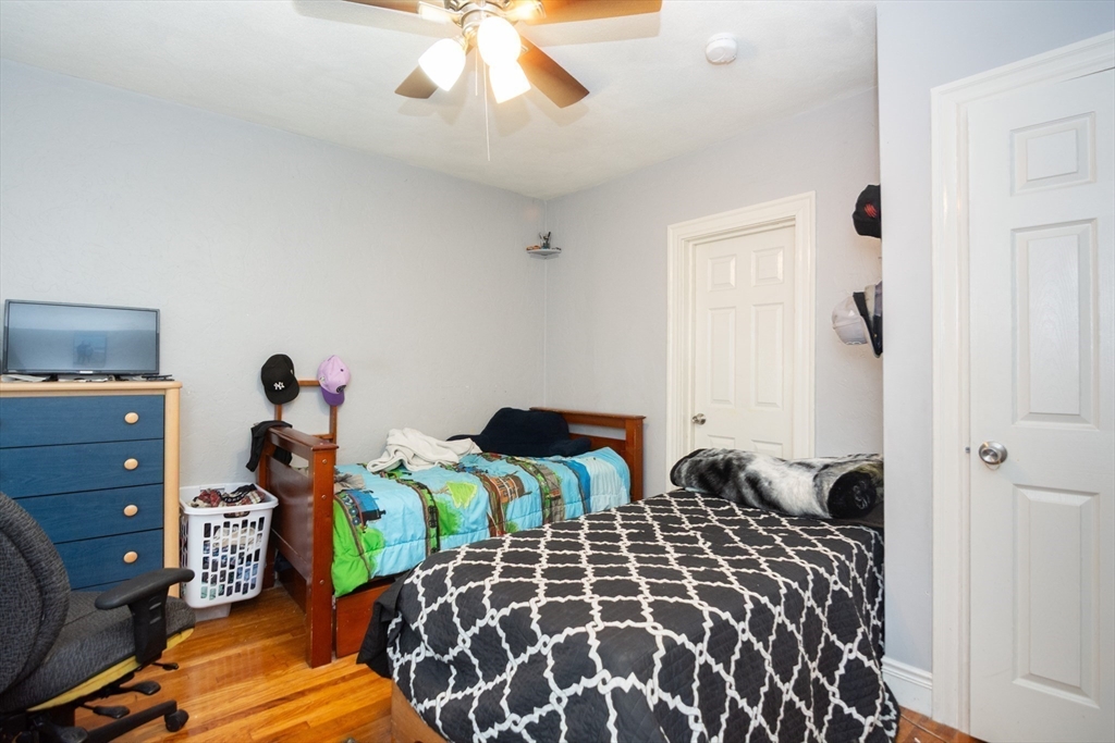 14 Russell Street Everett, MA 02149 - Photo 24 of 32 a bedroom with two beds and a chandelier