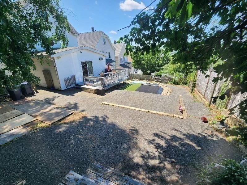 14 Russell Street Everett, MA 02149 - Photo 31 of 32 a view of a white house with a large tree next to a road