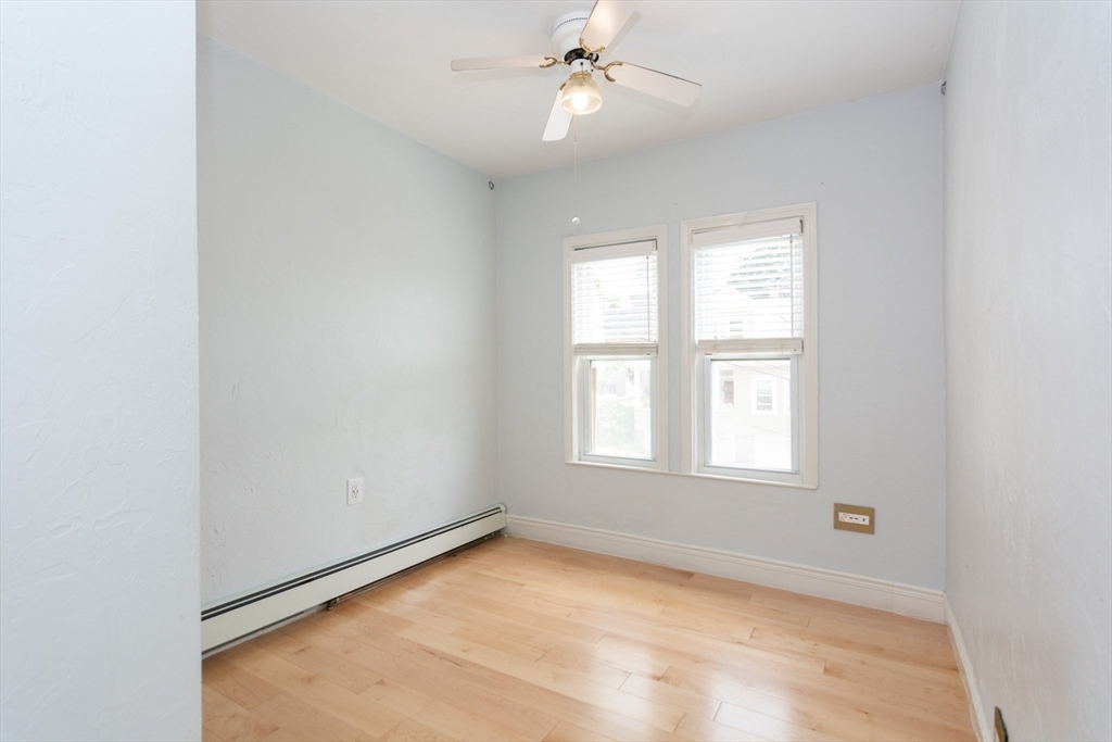 14 Russell Street Everett, MA 02149 - Photo 6 of 32 an empty room with chandelier fan and windows