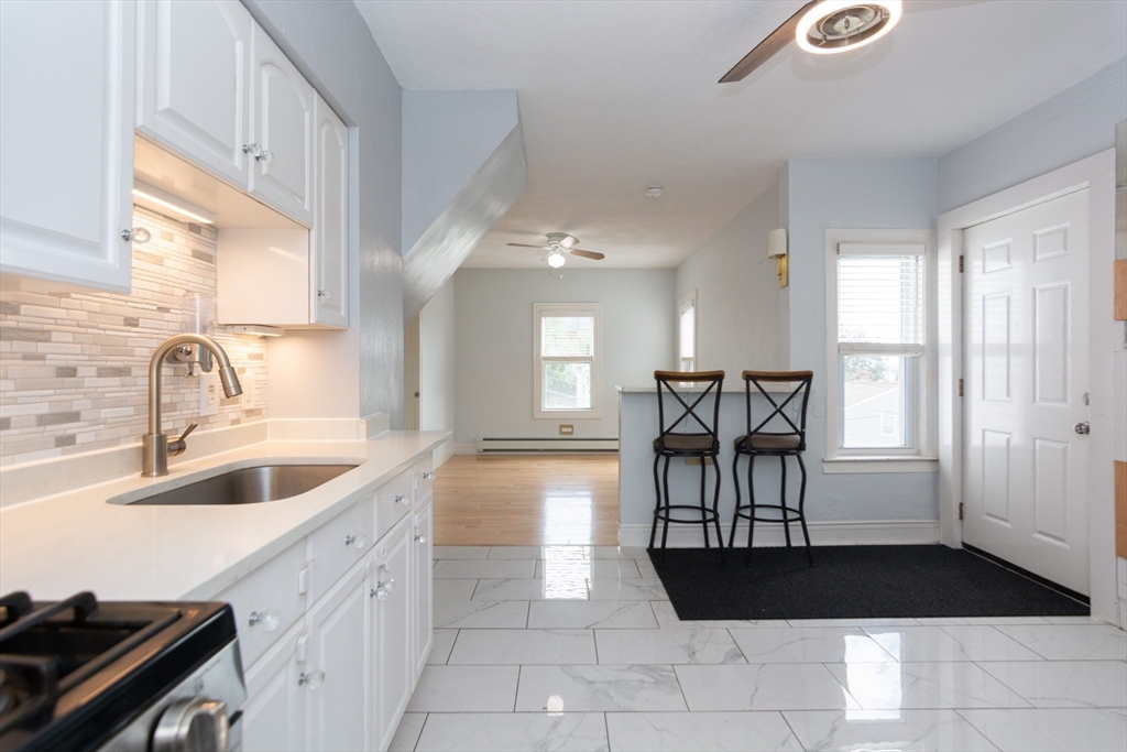 14 Russell Street Everett, MA 02149 - Photo 9 of 32 a kitchen with a sink and a refrigerator