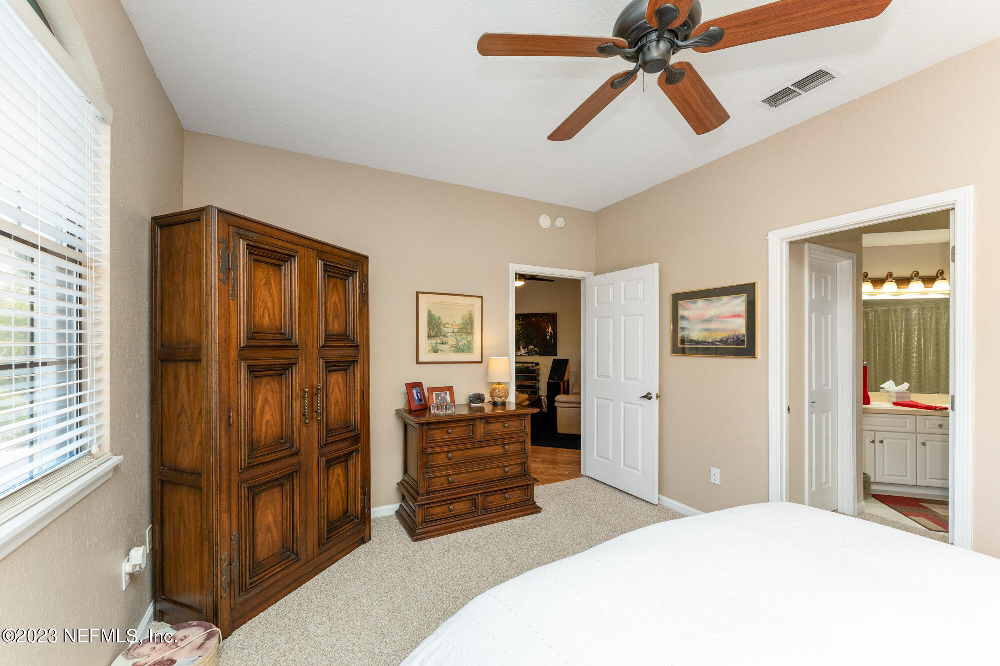 1321 Vista Cove Road St. Augustine, FL 32084 - Photo 14 of 27 a bedroom with a bed and a chandelier