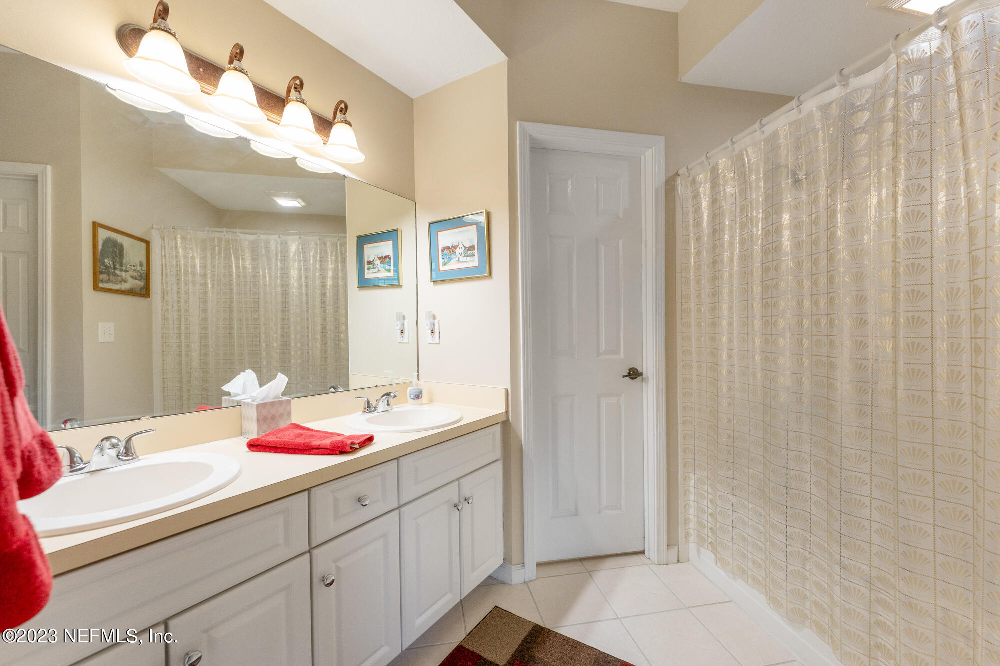 1321 Vista Cove Road St. Augustine, FL 32084 - Photo 15 of 27 a bathroom with a sink vanity and a mirror