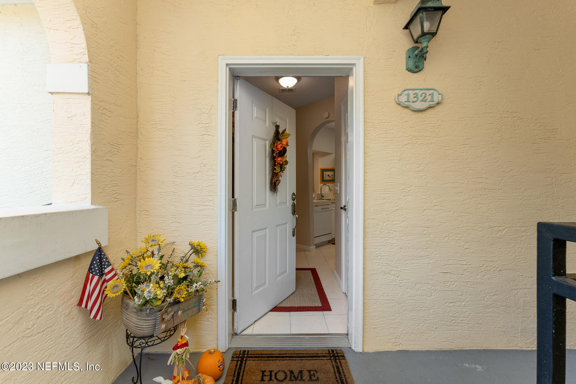1321 Vista Cove Road St. Augustine, FL 32084 - Photo 2 of 27 a view of a hallway with wooden floor and a potted plant