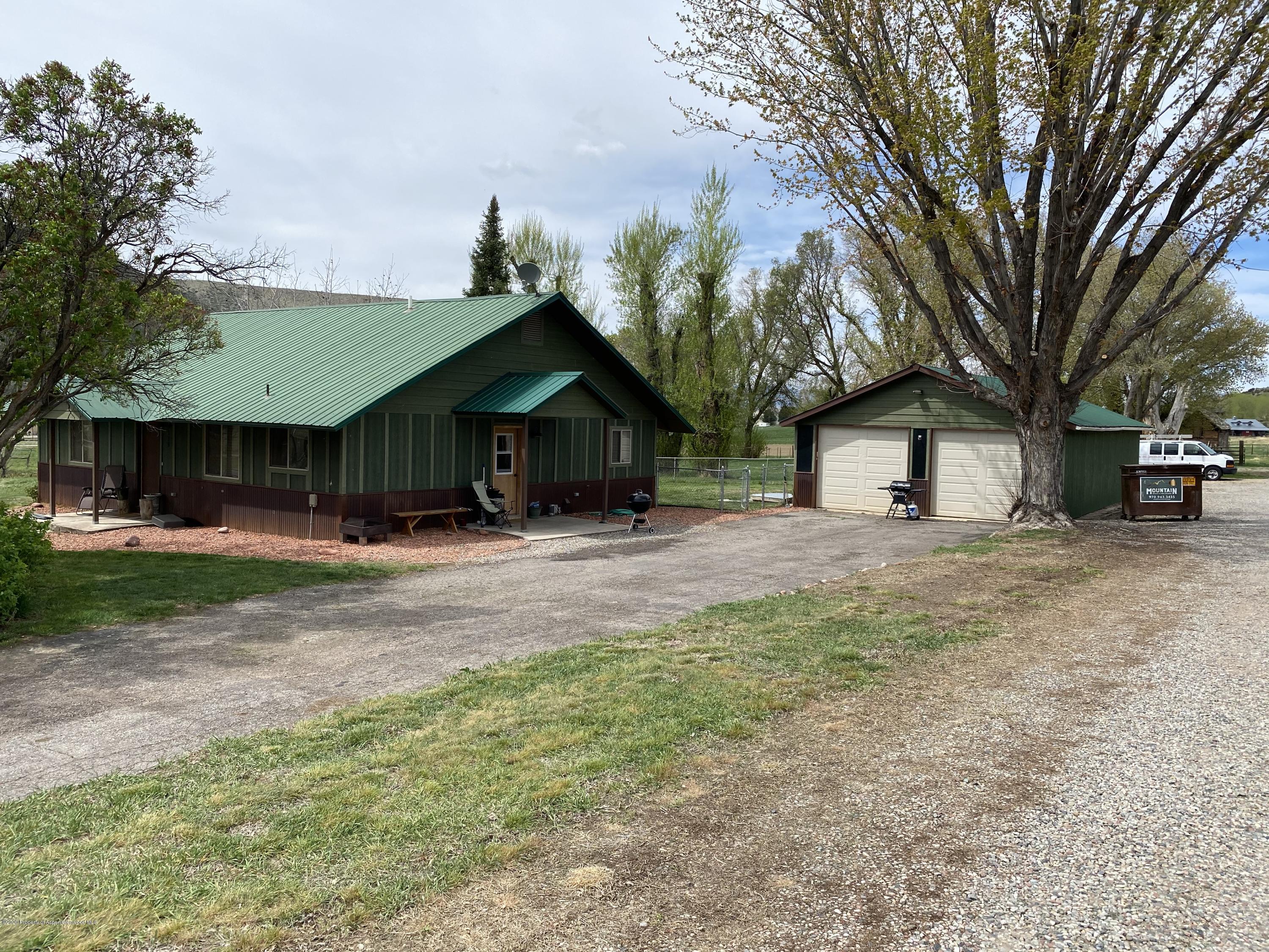 133 County Road 263 Silt, CO 81652 - Photo 1 of 16 a front view of a house with a yard and trees