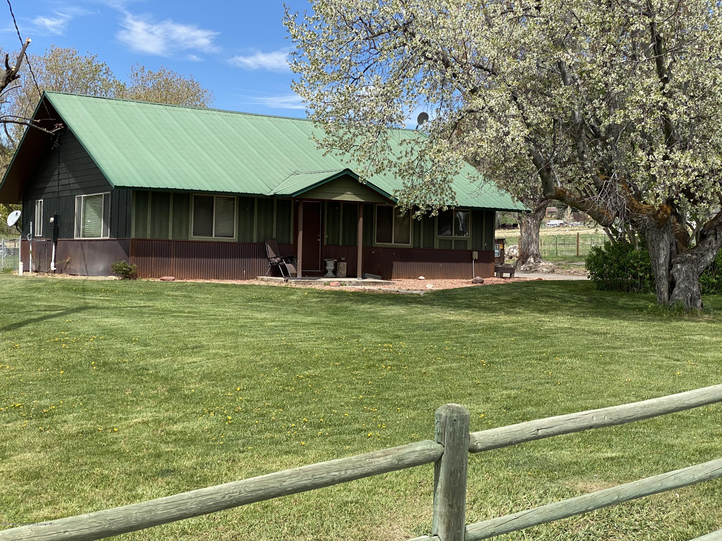 133 County Road 263 Silt, CO 81652 - Photo 3 of 16 a front view of a house with a yard