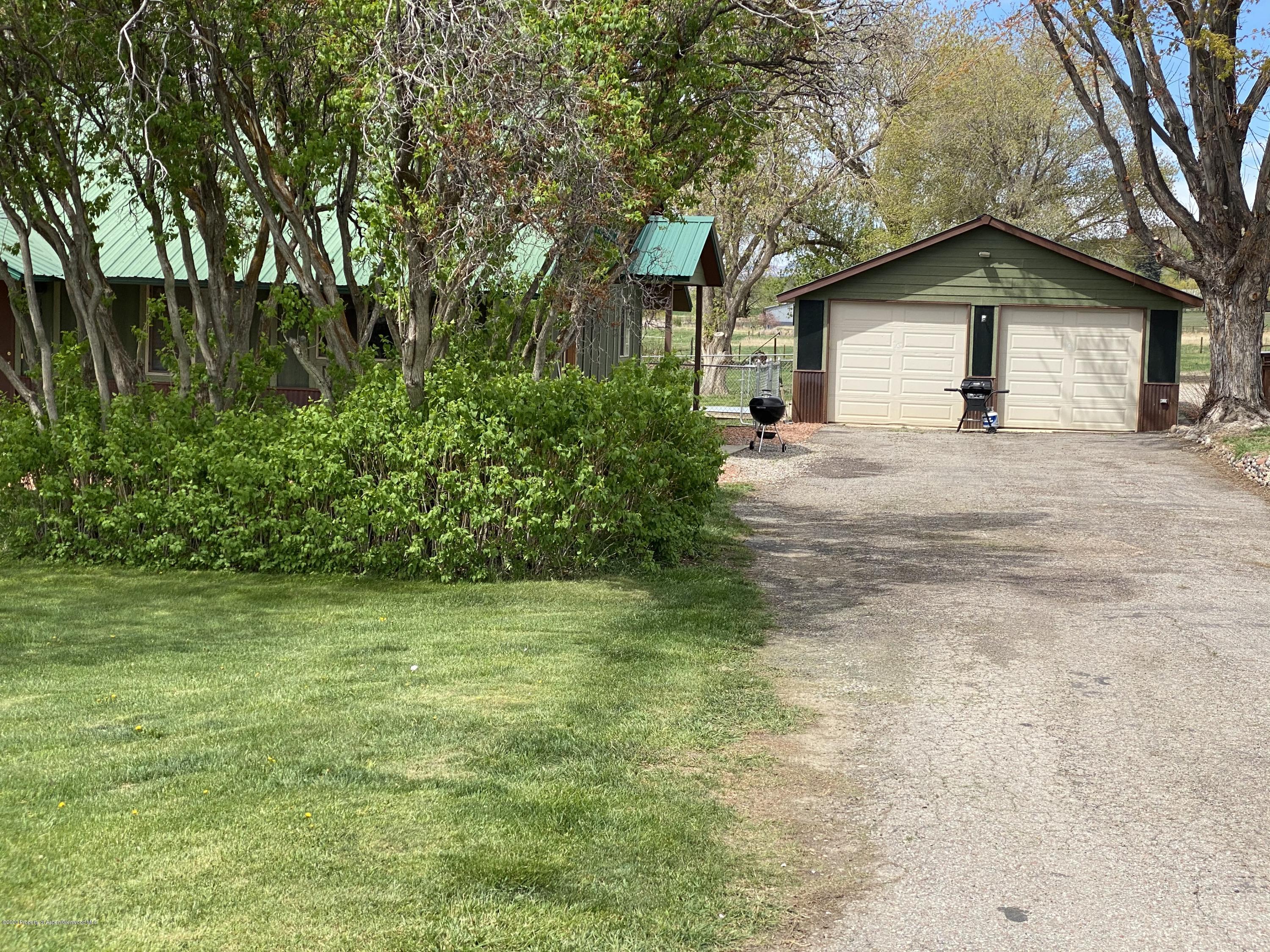 133 County Road 263 Silt, CO 81652 - Photo 4 of 16 a front view of a house with a garden