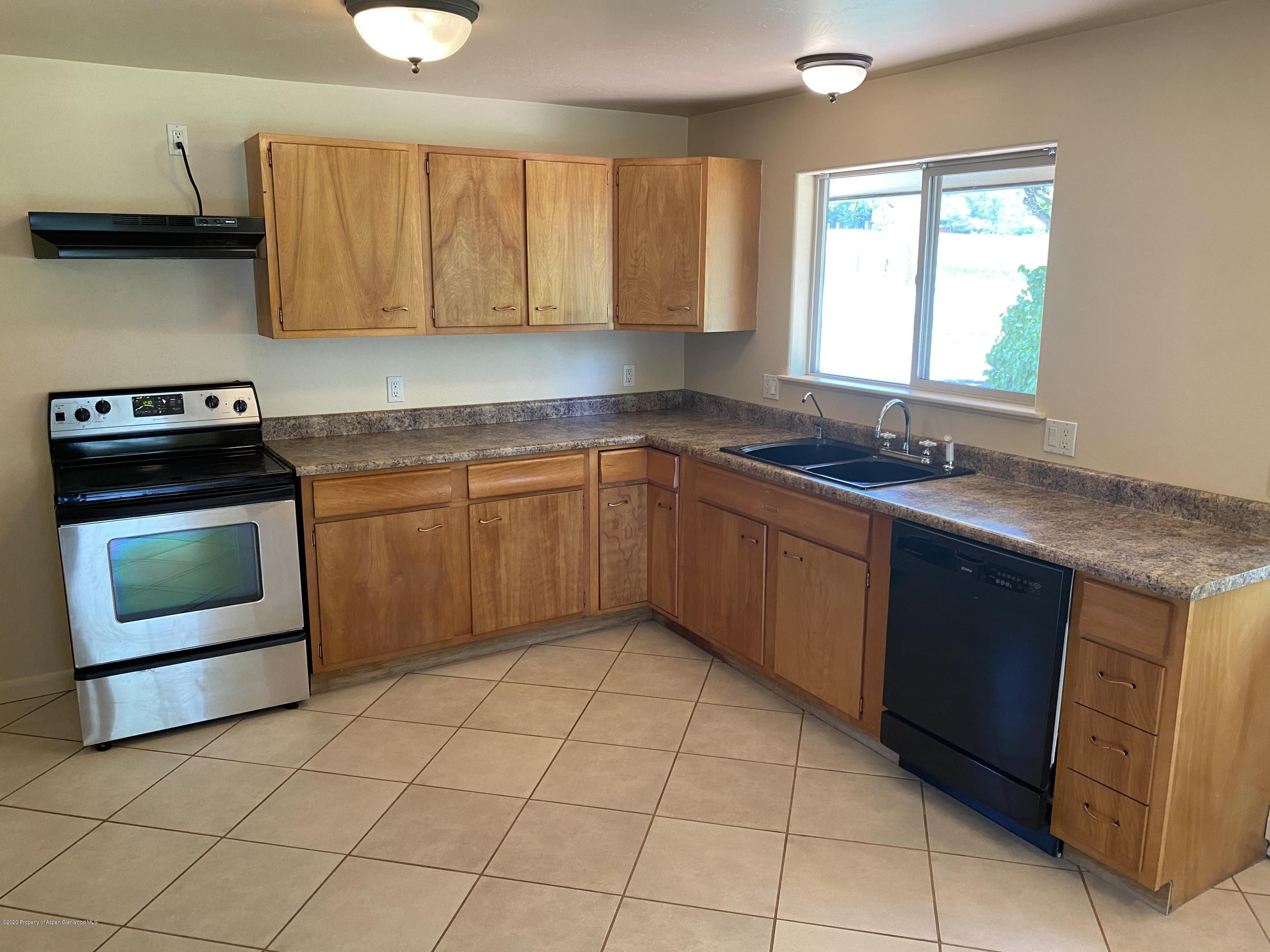 133 County Road 263 Silt, CO 81652 - Photo 6 of 16 a kitchen with a sink stove top oven and cabinets