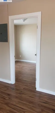 a room with wooden floor and a window