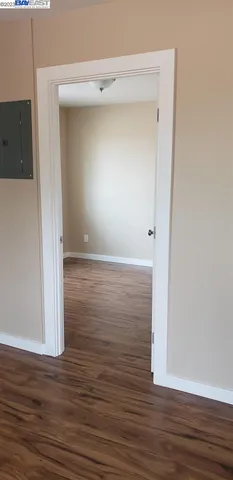 a room with wooden floor and a window