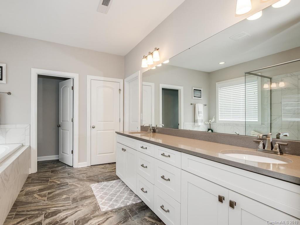 5390 Meadowcroft Way Fort Mill, SC 29708 - Photo 15 of 33 a spacious bathroom with a granite countertop sink and a mirror