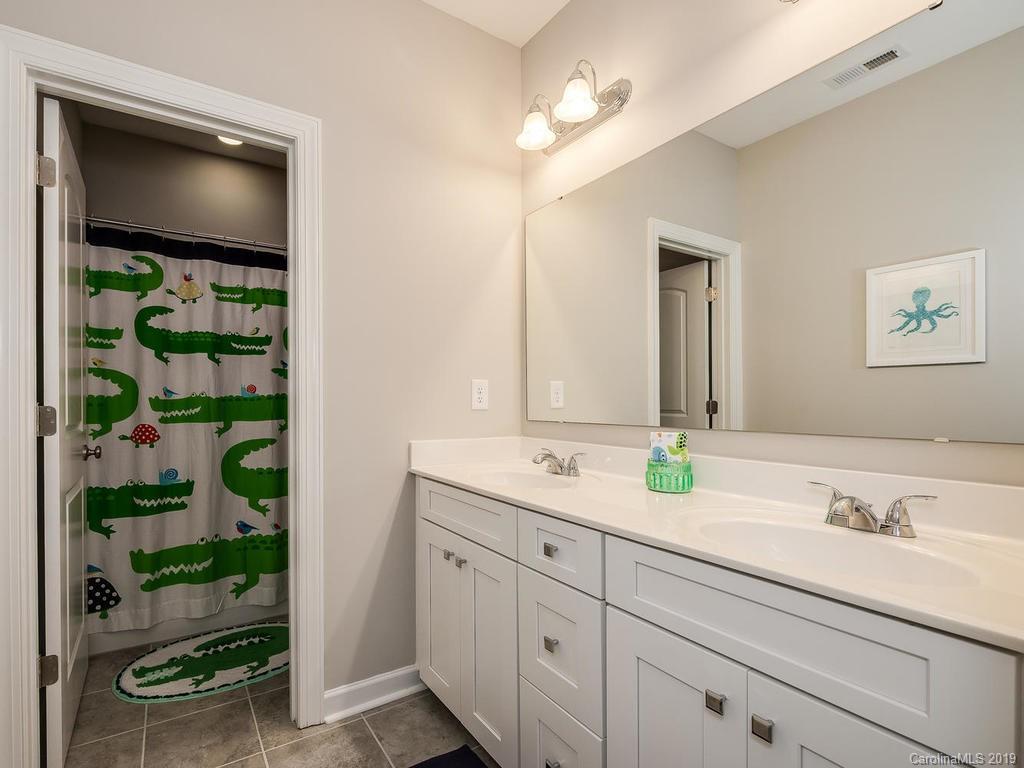 5390 Meadowcroft Way Fort Mill, SC 29708 - Photo 22 of 33 a bathroom with a granite countertop sink and a mirror