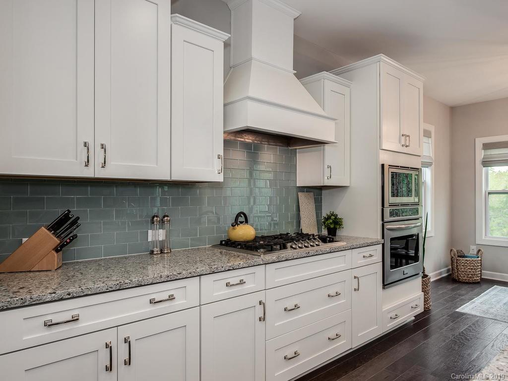 5390 Meadowcroft Way Fort Mill, SC 29708 - Photo 7 of 33 a kitchen with granite countertop white cabinets and stainless steel appliances