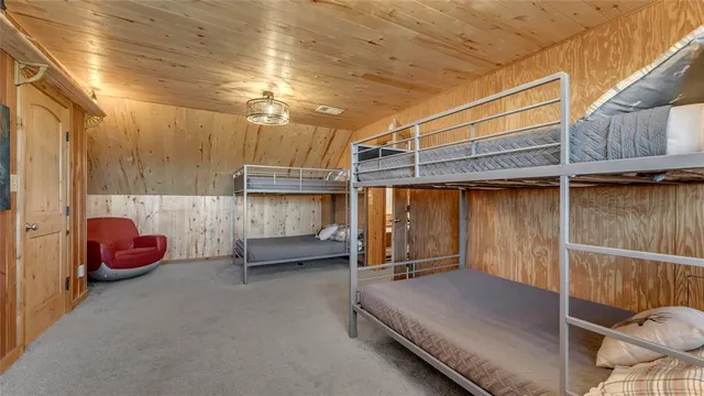 a living room with patio furniture and a wooden floor