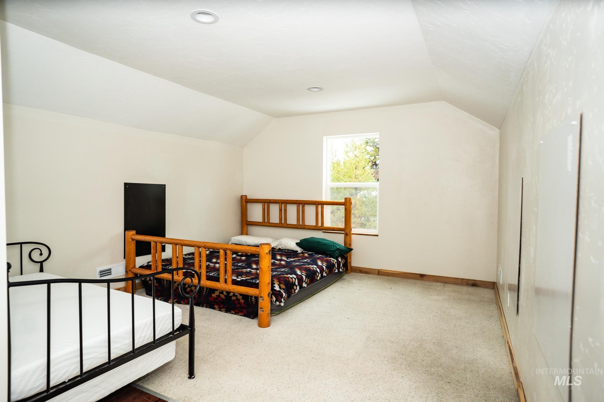 22 West Prospectors Drive Cascade, ID 83611 - Photo 13 of 29 Bedroom featuring lofted ceiling and carpet flooring