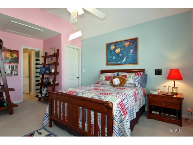 3-n943 Ralph Waldo Emerson Lane St. Charles, IL 60175 - Photo 12 of 24 a bedroom with a bed a dresser and book shelf