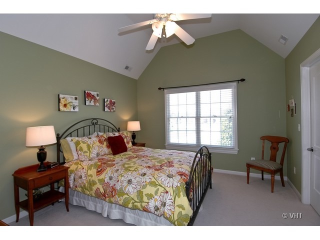 3-n943 Ralph Waldo Emerson Lane St. Charles, IL 60175 - Photo 13 of 24 a bedroom with a bed and a chandelier