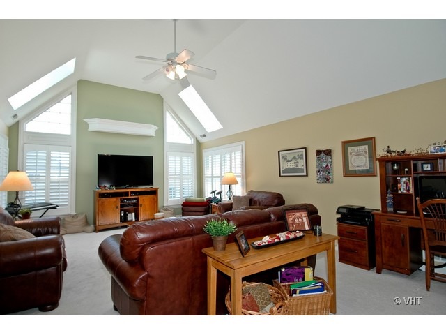 3-n943 Ralph Waldo Emerson Lane St. Charles, IL 60175 - Photo 14 of 24 a living room with furniture a flat screen tv and a large window