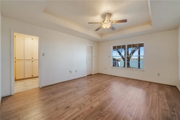 a view of an empty room and wooden floor