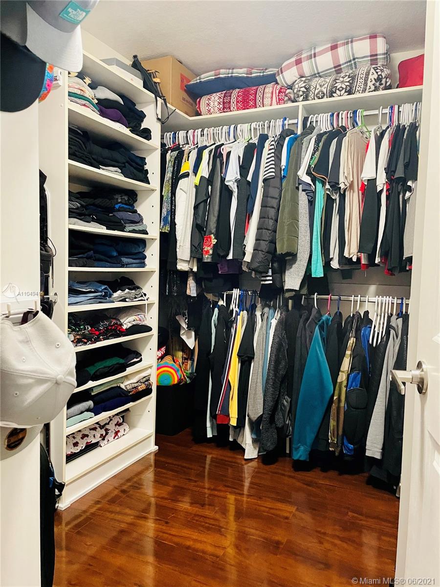 Aventura Aventura, FL 33180 - Photo 18 of 37 a view of walk in closet with clothes and shoes