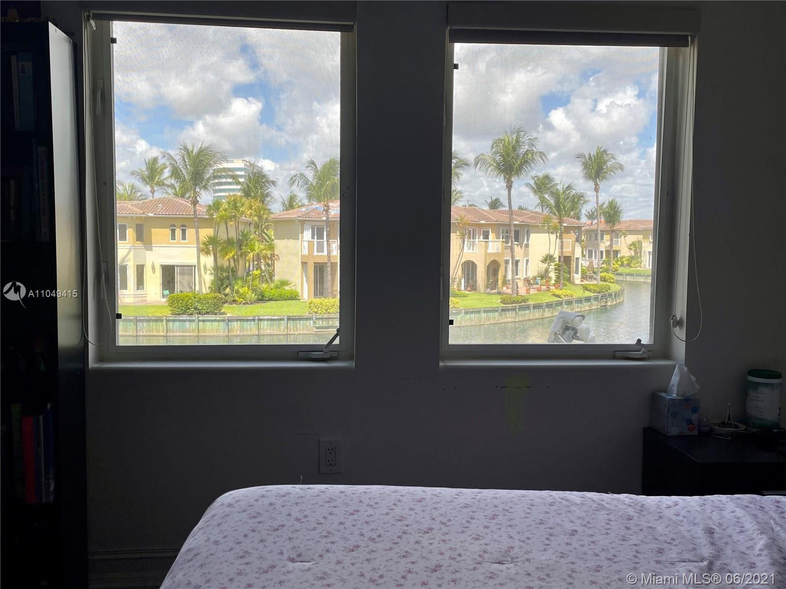 Aventura Aventura, FL 33180 - Photo 19 of 37 a bedroom with a bed lamp and large window