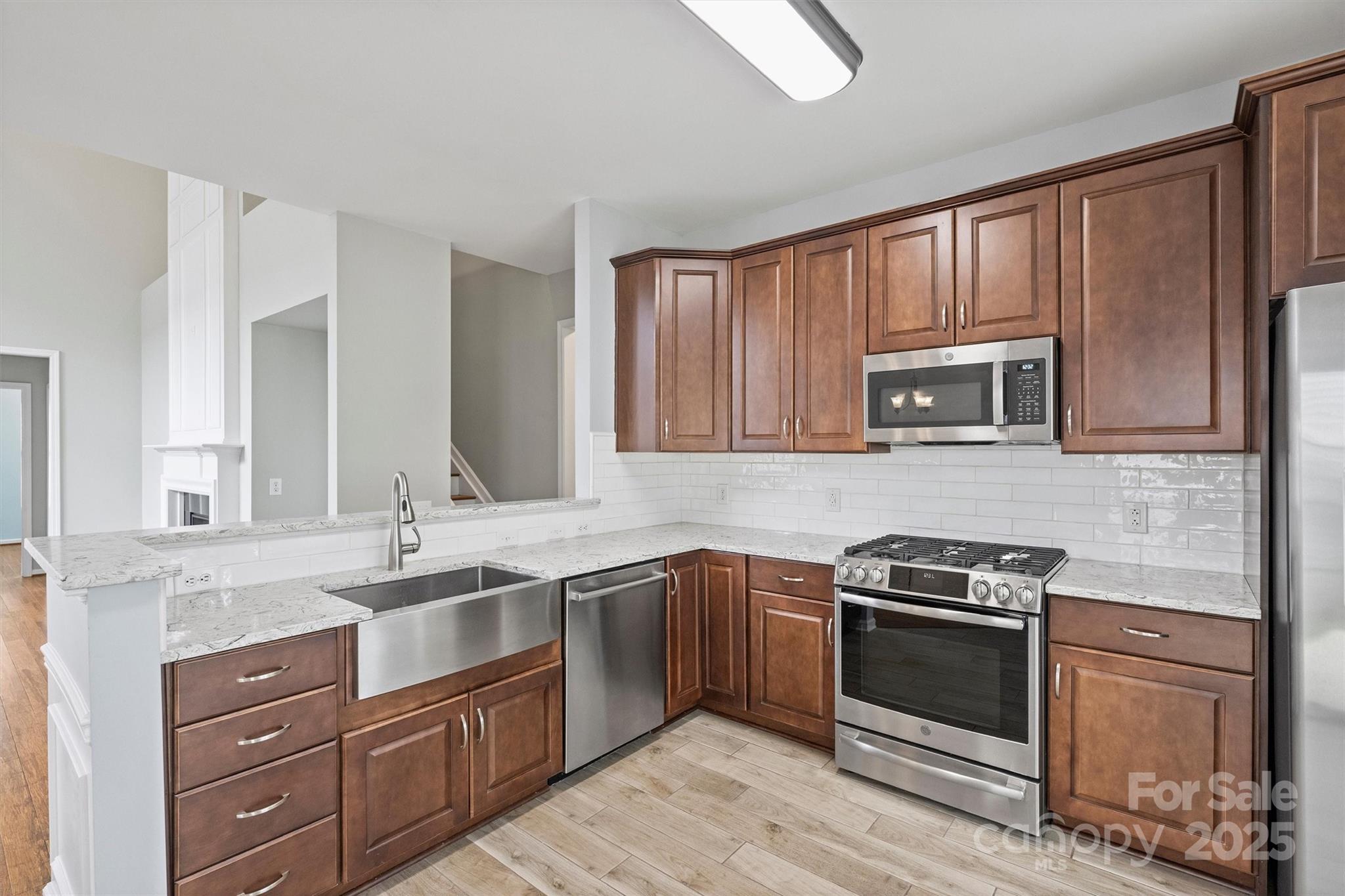 11422 Nevermore Way Charlotte, NC 28277 - Photo 11 of 34 a kitchen with a sink stove and microwave