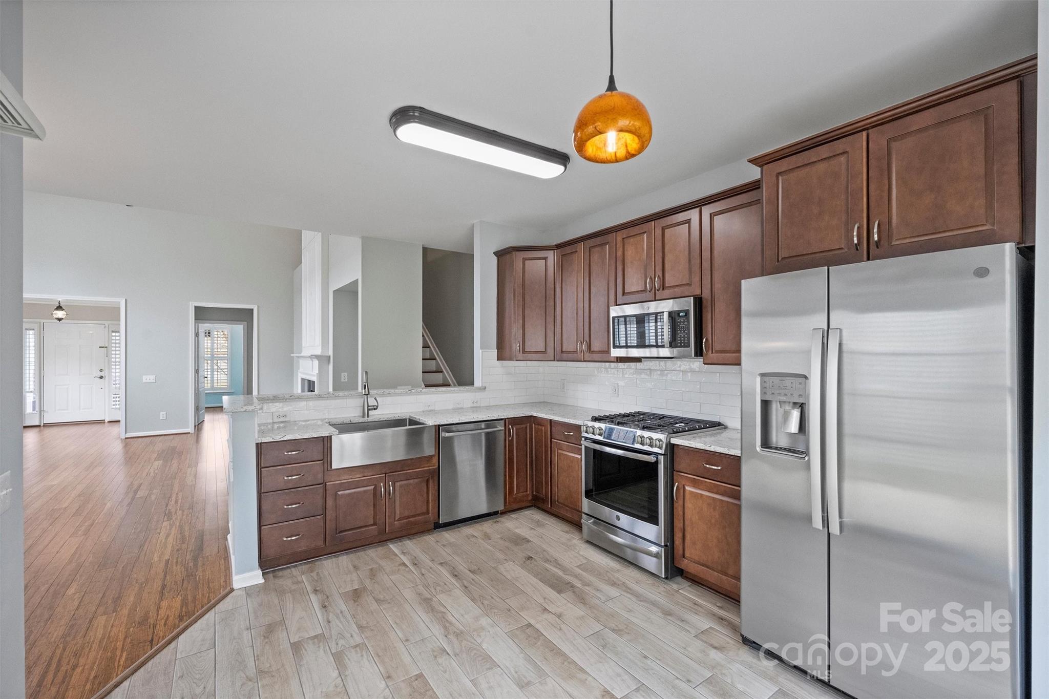11422 Nevermore Way Charlotte, NC 28277 - Photo 12 of 34 a kitchen with stainless steel appliances granite countertop a stove refrigerator and microwave