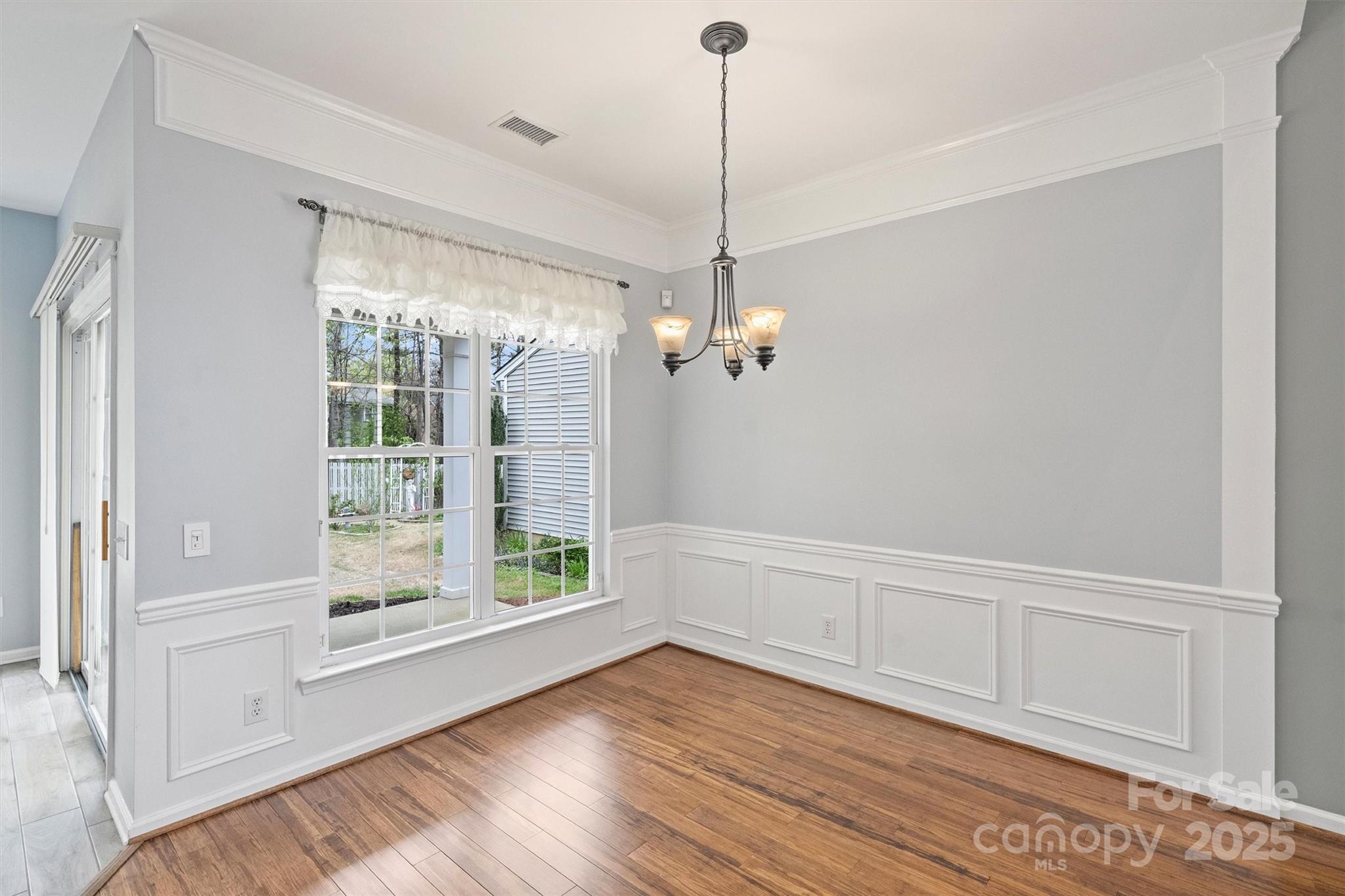 11422 Nevermore Way Charlotte, NC 28277 - Photo 14 of 34 a view of empty room with wooden floor and fan
